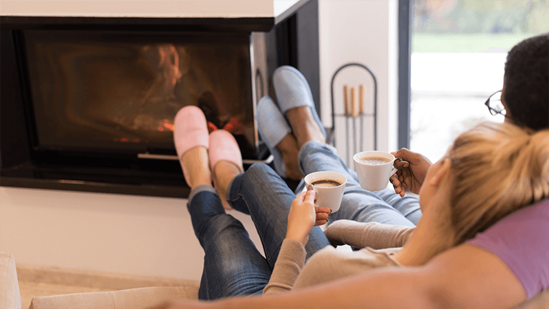 Couple cozy by fireplace